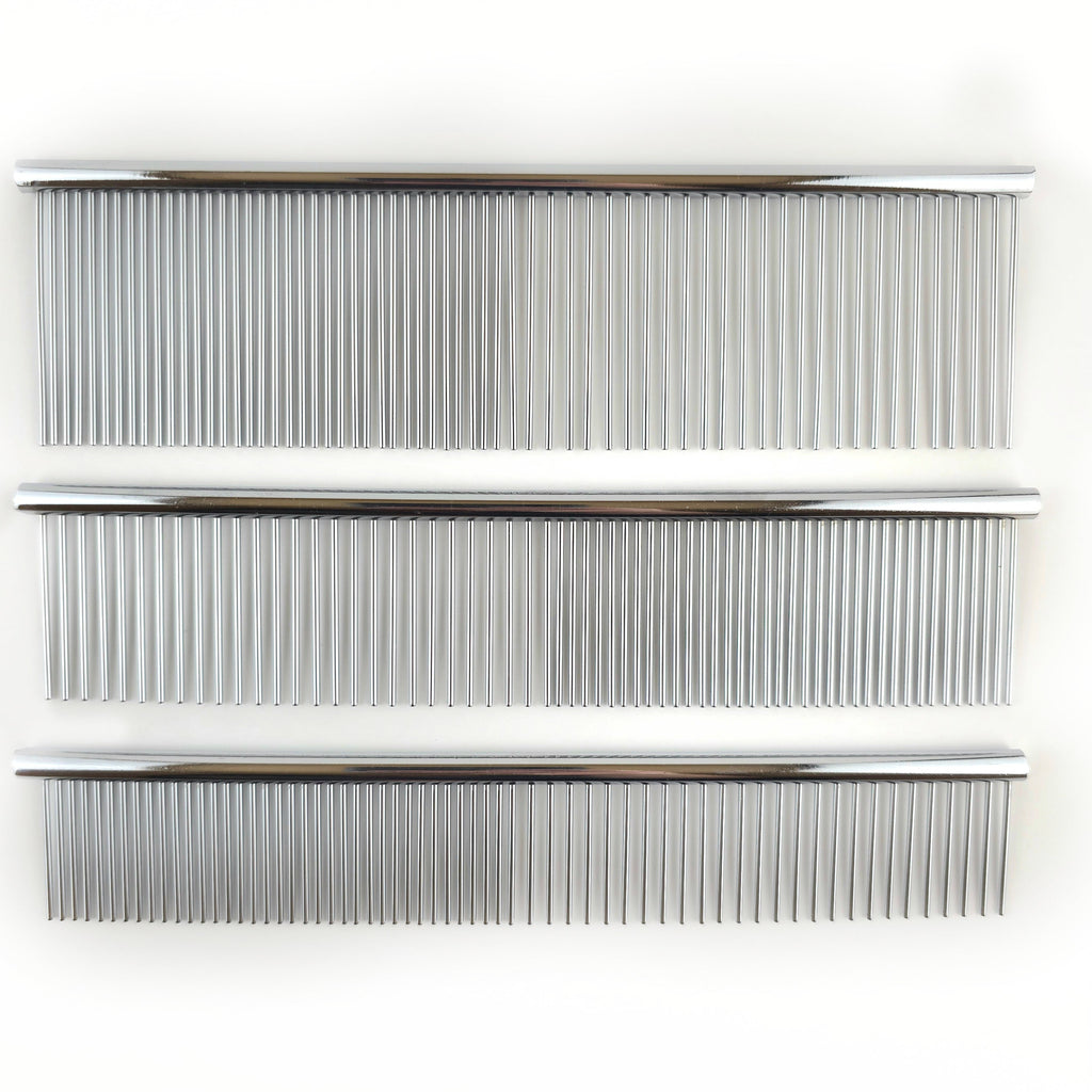 Three metal combs of different sizes on a white background