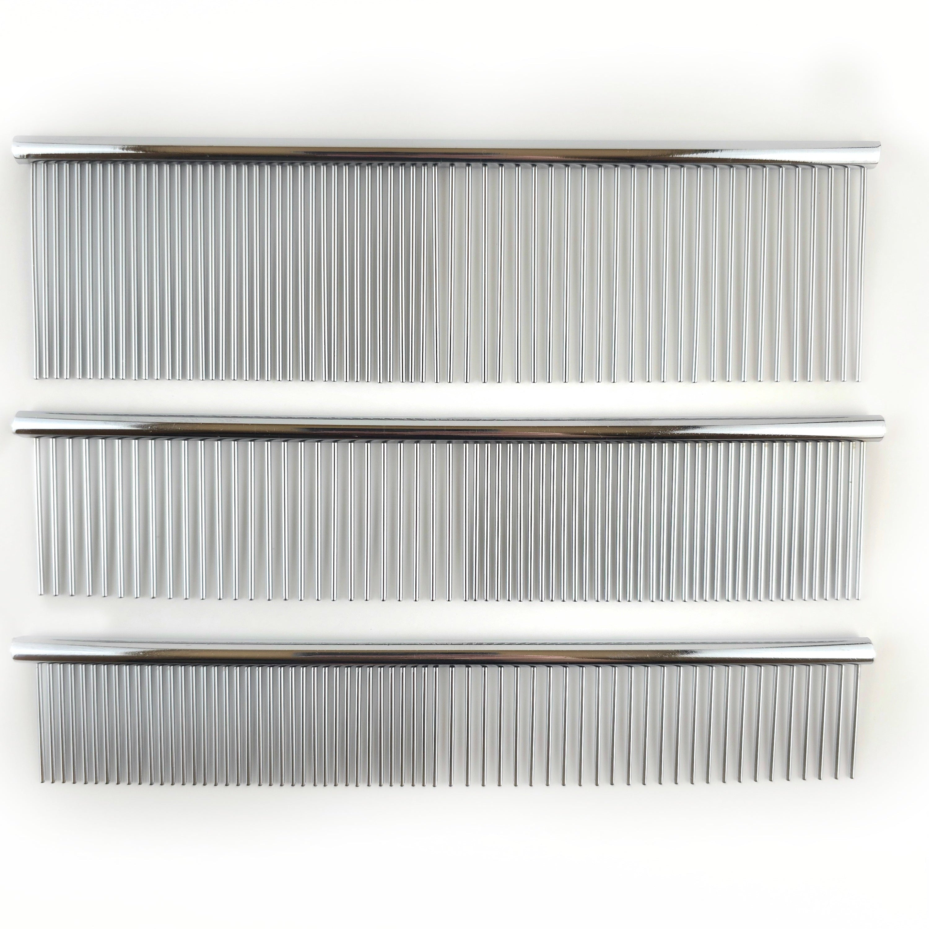 Three metal combs of different sizes on a white background