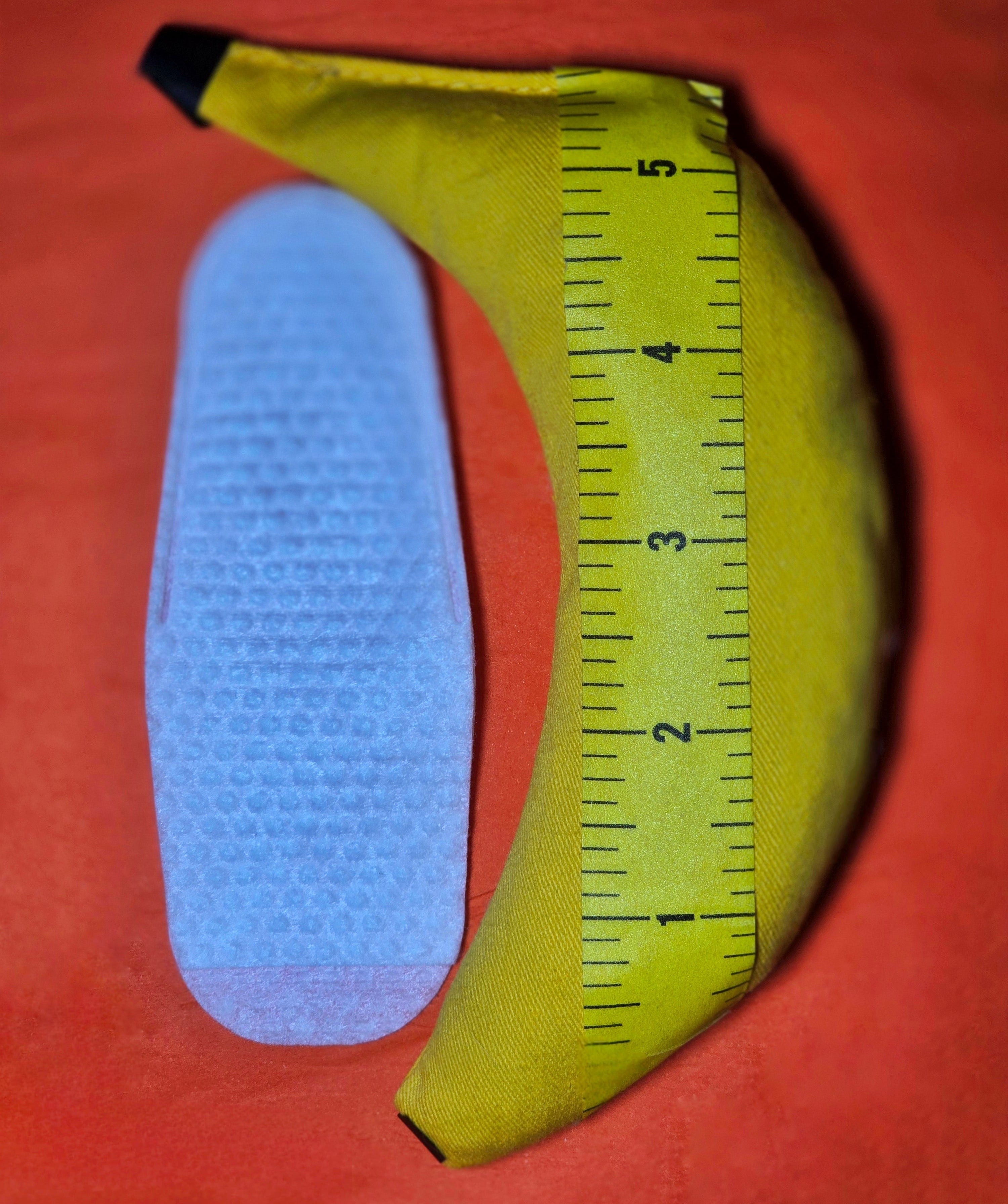 Yellow measuring tool with a finger wipes on a orange background