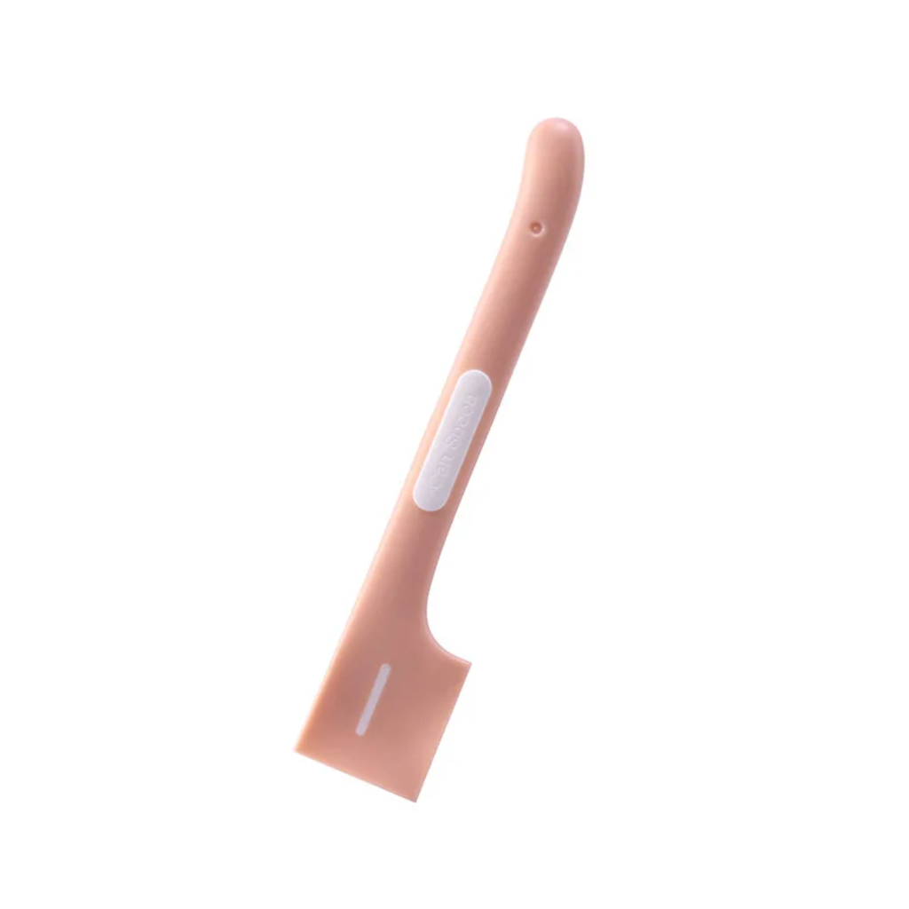 Pink silicone spoon a white background