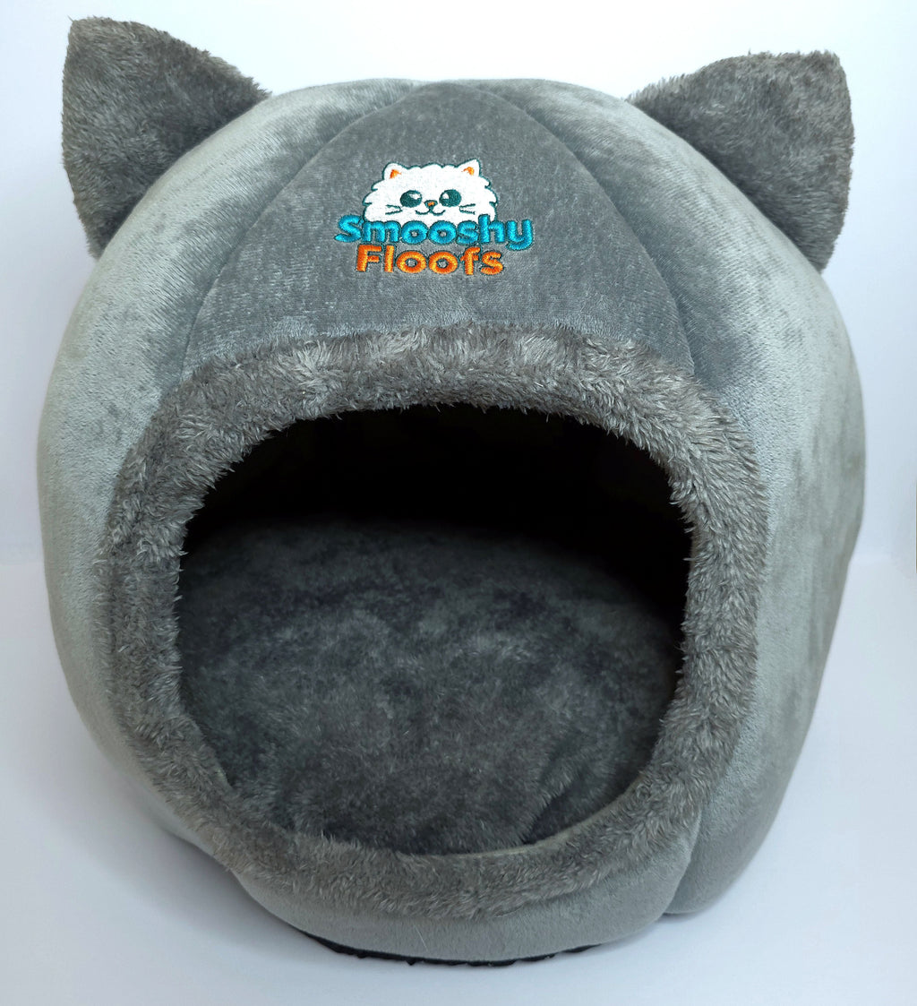 Gray pet bed with cat ears and 'Smooshy Floofs' logo on a white background