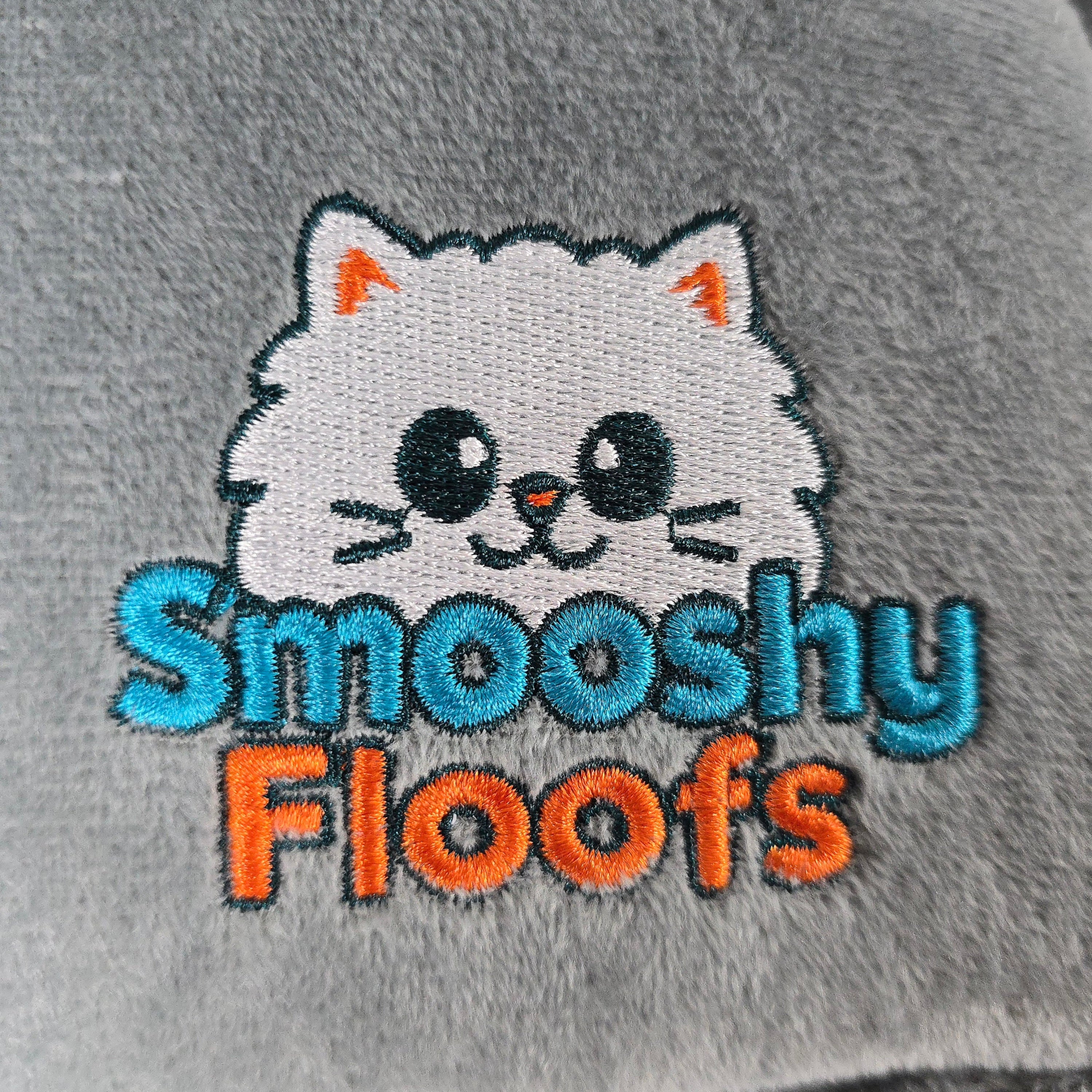 cat logo and 'Smooshy Floofs' text on a gray background of catbed