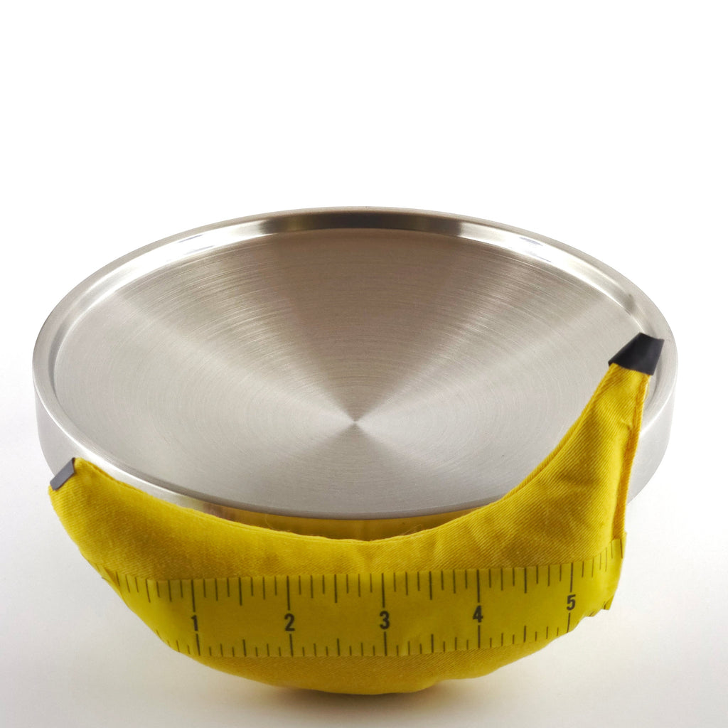 Metallic plate with a yellow measuring tape wrapped around it on a gray background