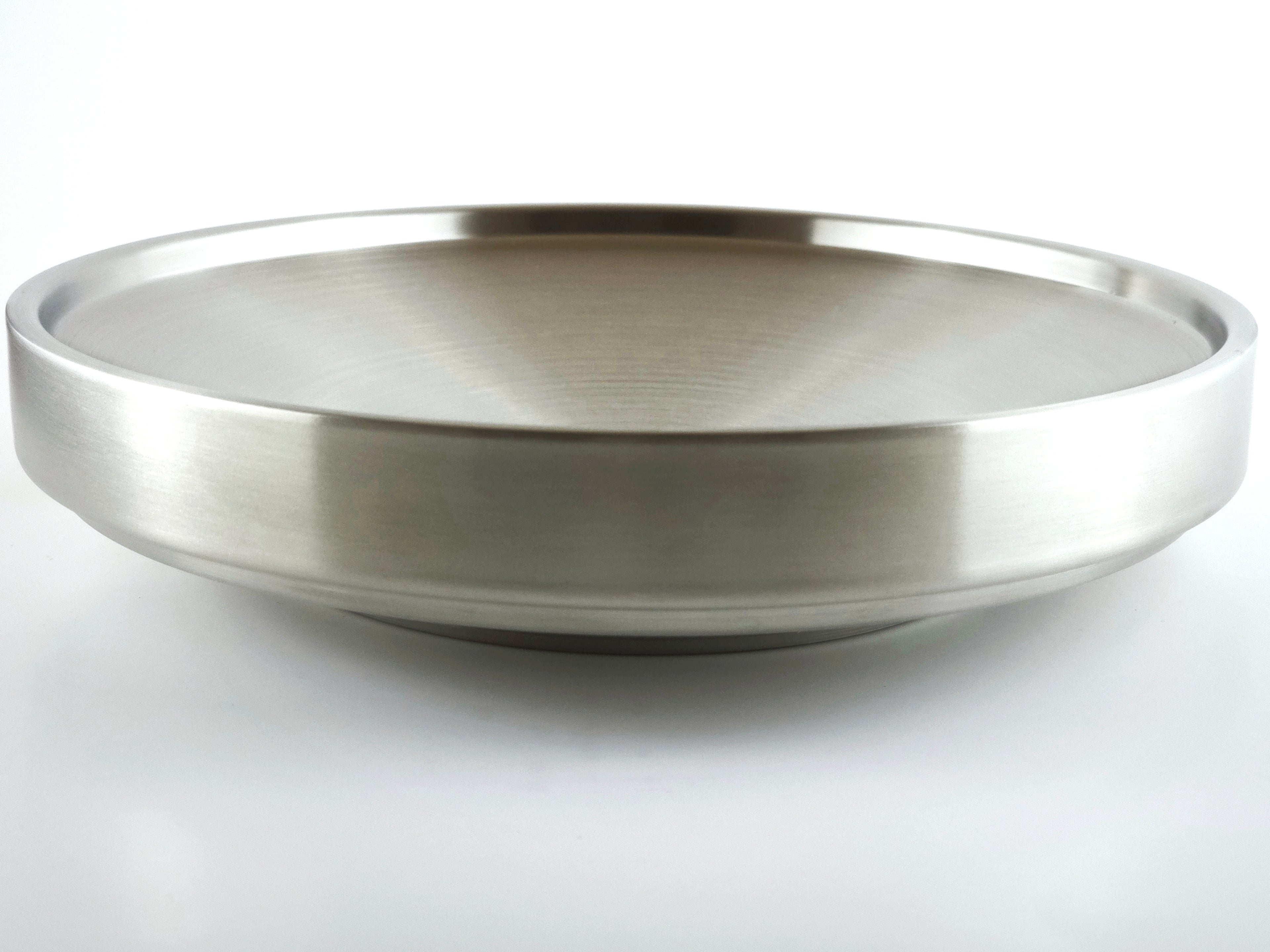 Stainless steel plate on a light gray background