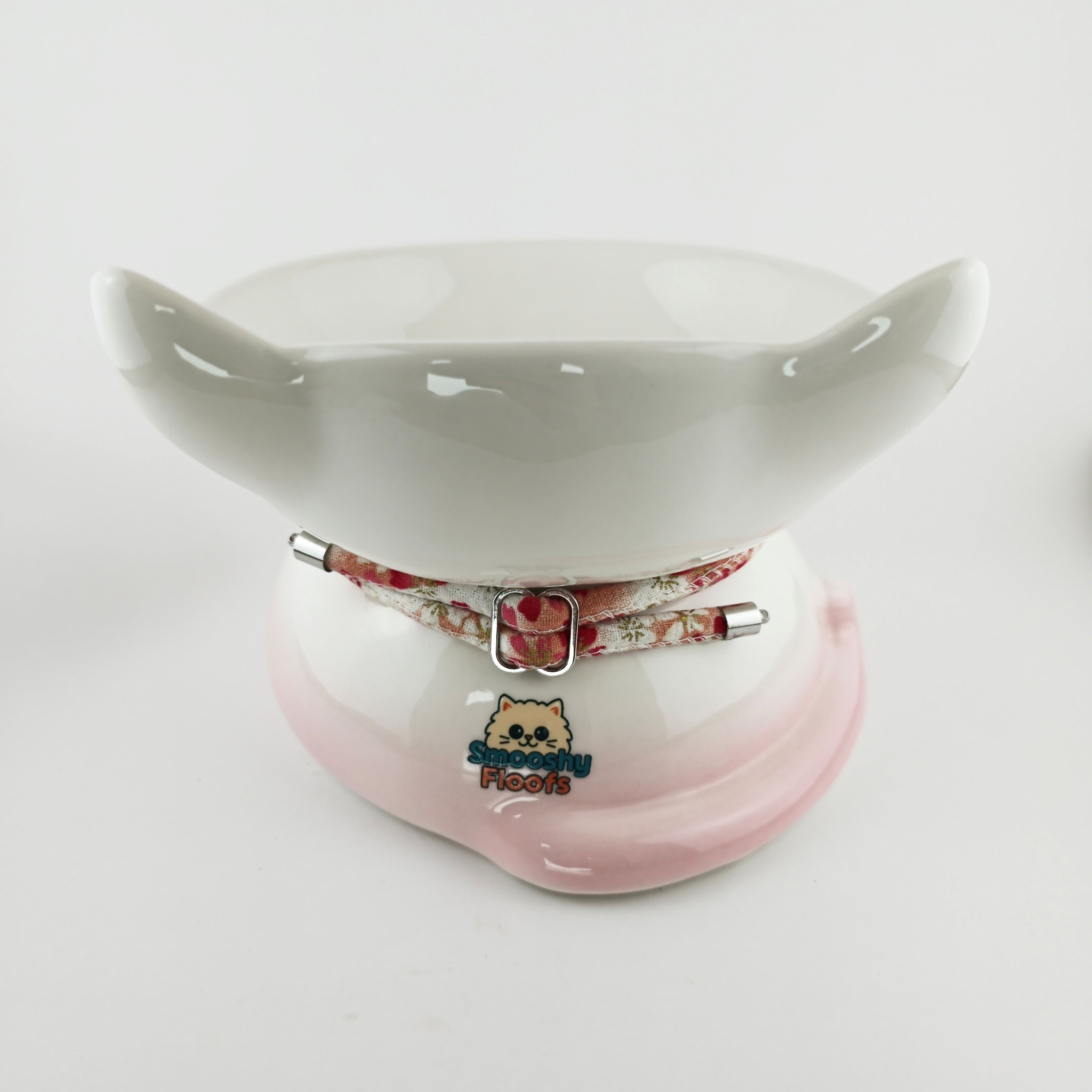 Ceramic bowl with pink base and white top on a light gray background
