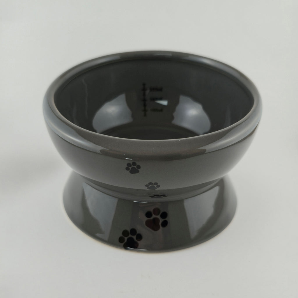 Gray ceramic pet bowl with paw prints on a white background