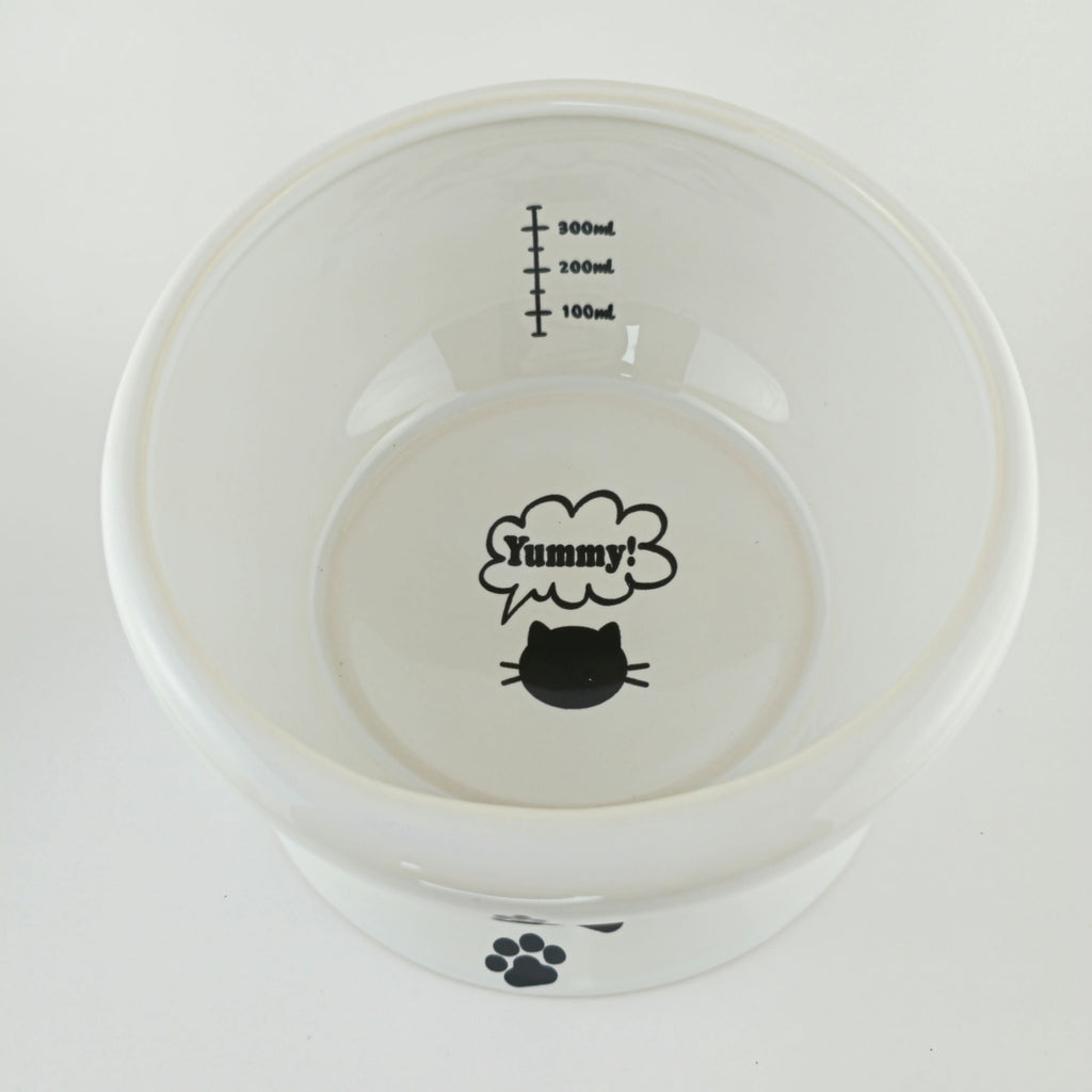 White pet bowl with black text and graphics on a white background