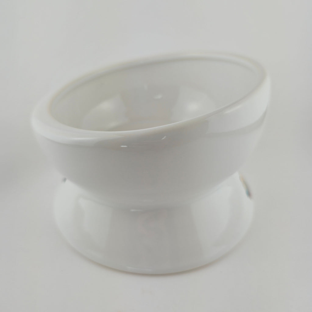 White plastic component on a light gray background