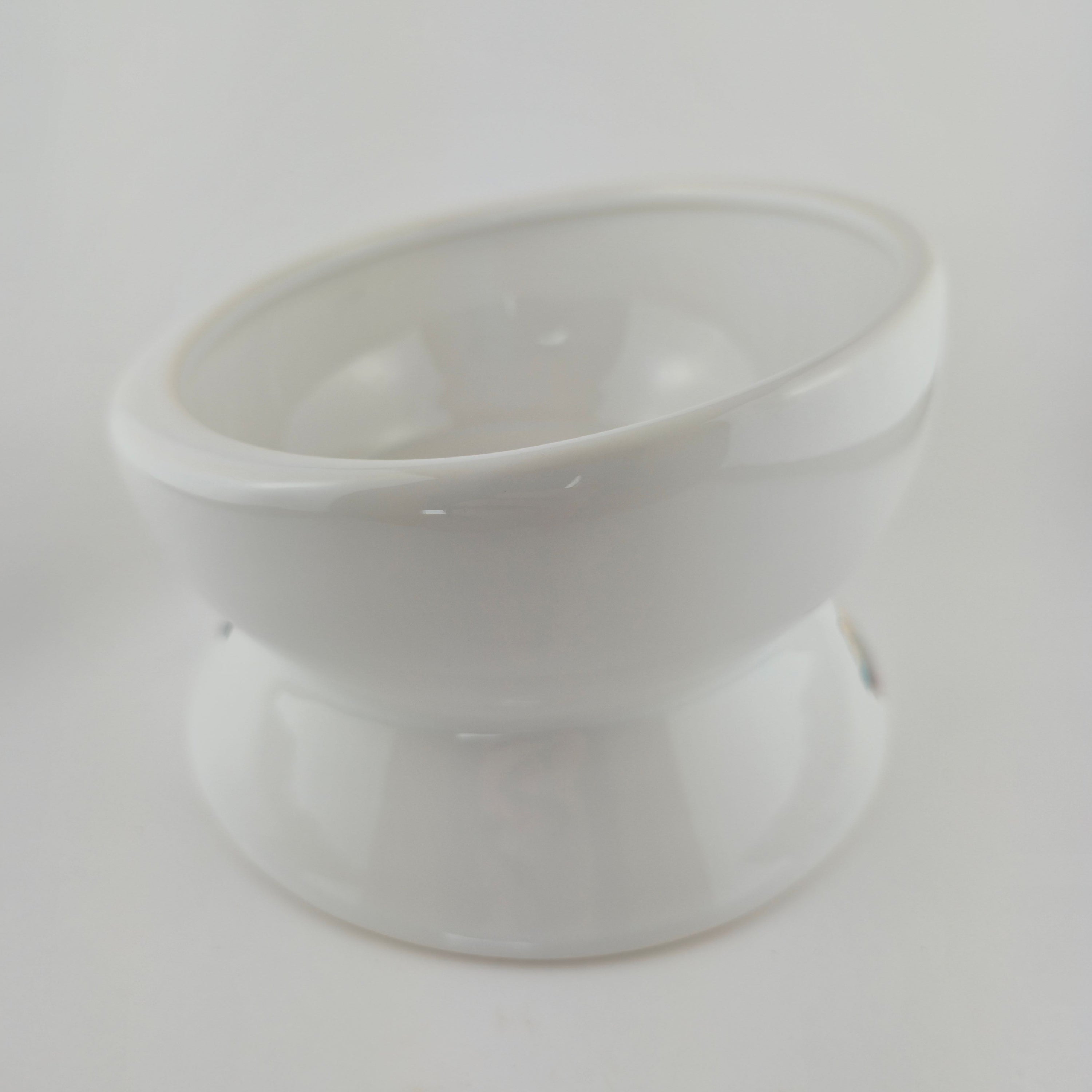 White plastic component on a light gray background