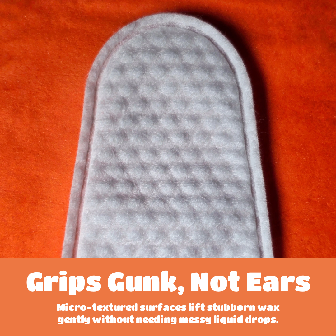 A close-up of a light gray textured earbud grip pad on a bright orange background, with an orange text banner at the bottom reading 'Grips Gunk, Not Ears' and supporting copy about lifting stubborn wax.